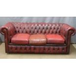 A red leather three seat Chesterfield sofa, W190 x D82 x H76cm