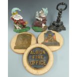 Three cast iron door stops including Mr Punch and three replica fire marks