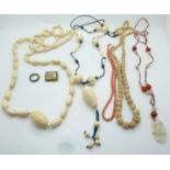 A collection of beaded necklaces including ivory, coral, Chinese agate, nephrite jade ring, and