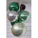 Six glass witch's balls or oversized baubles, diameter of largest approximately 25cm, and a small