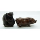 Japanese netsuke depicting a dog holding a shell between its legs, together with a vintage