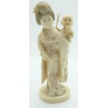 Japanese Meiji period okimono of a lady with child playing with a catapult, signed to base, H12cm