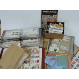 A collection of all world stamps in two boxes including first day covers, albums, loose stamps etc