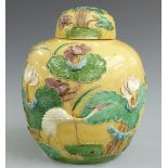 A late 19thC Chinese yellow glaze ginger jar with crane and floral decoration in relief with four