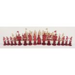 A 19thC/early 20thC Chinese carved ivory part puzzle ball chess set, one side stained red, height of