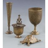 Four Eastern metal items including an unusual vessel featuring a figure carrying another figure