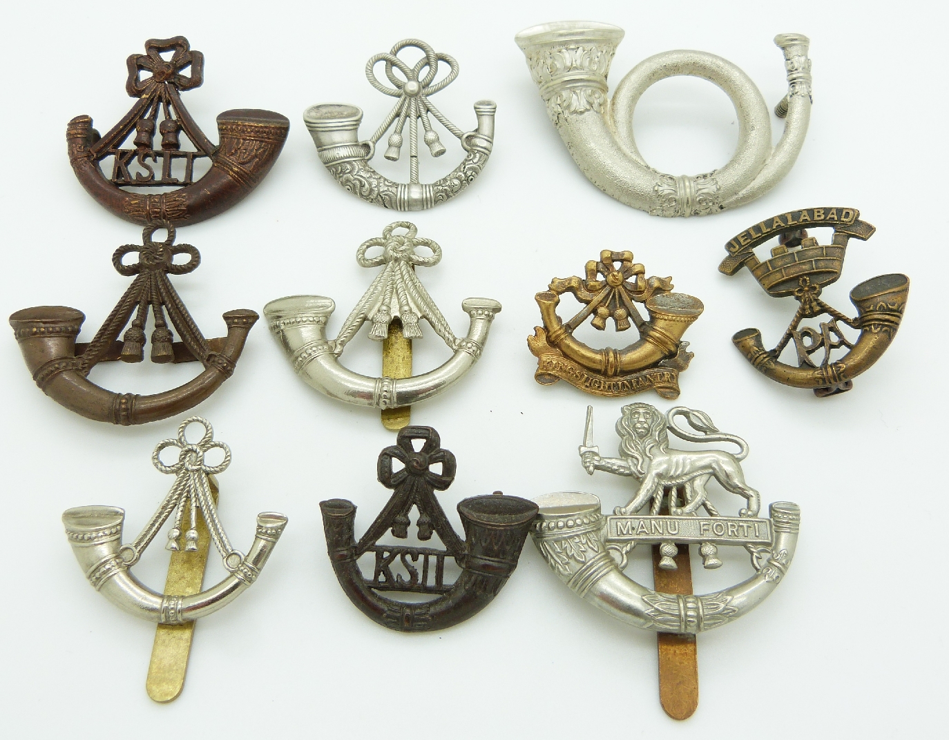 Ten British Army Light Infantry Regiments metal badges including King's Light Infantry, Hereford