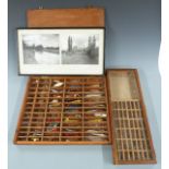 Vintage fishing lures and trout fishing flies in two cases including a hinged 'Plucky' lure, painted