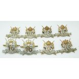 Eight British Army 16th Lancers metal badges with King's and Queen's crowns