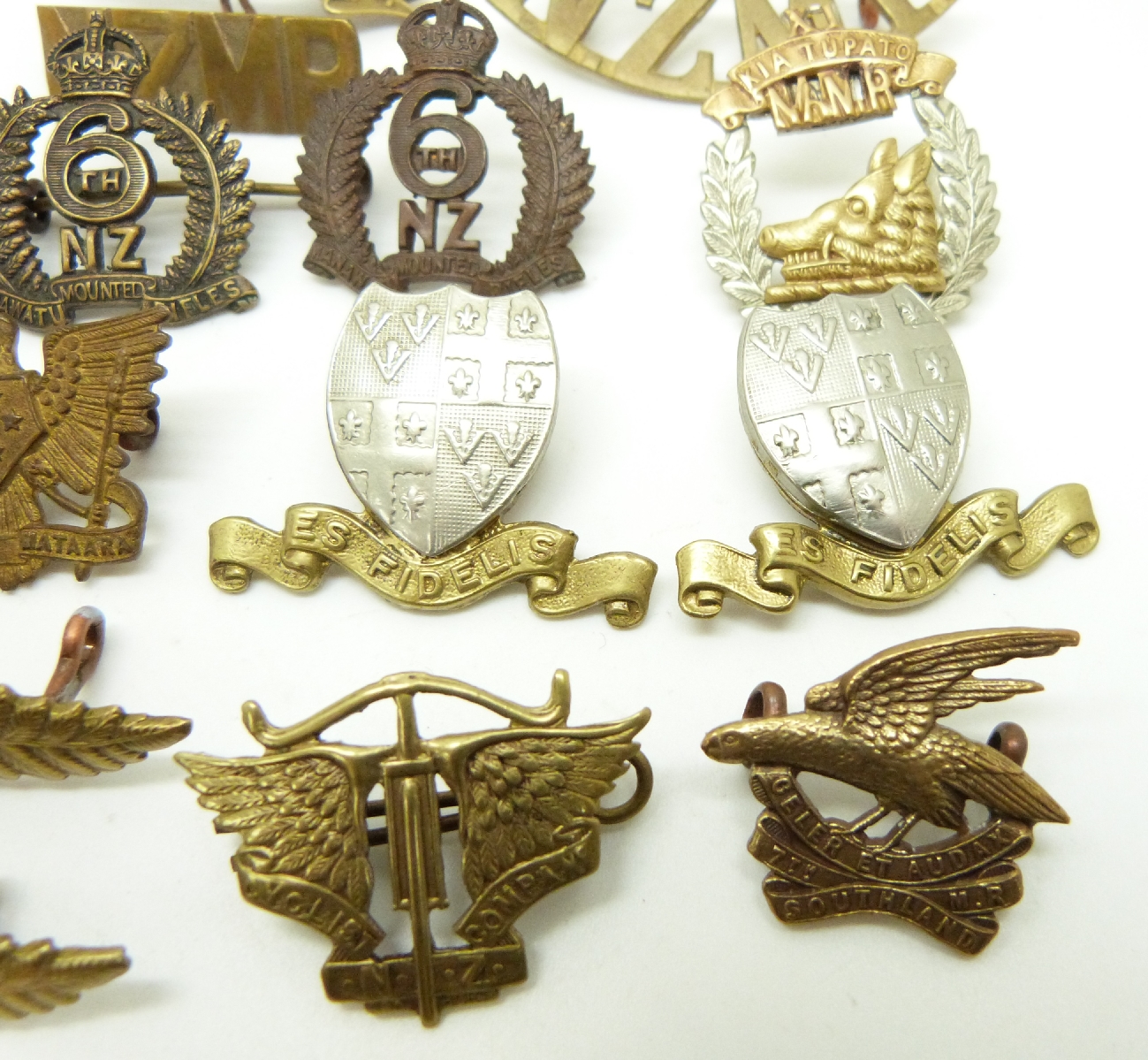 Seventeen New Zealand Army metal cap badge, collar badges and shoulder ...