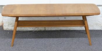 Ercol light elm coffee table raised on four retro legs with magazine undershelf, 35 x 107 x 45cm