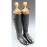 A pair of leather riding boots with wooden trees, "Hawkins by appointment to the Queen, E style