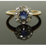 An 18ct gold ring set with a sapphire surrounded by old cut diamonds, size M, 2.86g