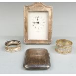 Kitney & Co. hallmarked silver mounted clock, two hallmarked silver napkin rings and a hallmarked