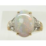 A 9ct gold ring set with an oval cabochon black opal of approximately 3.1ct and diamonds, 3.2g, size