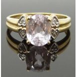 A 9ct gold ring set with an oval cut morganite and diamonds, size N, 2.77g