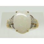 A 9ct gold ring set with an oval opal and diamonds, 2.9g, size N
