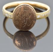 Georgian ring set with a gold cartouche engraved with initials and white enamel to the band