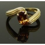 A 9ct gold ring set with an oval cut citrine, size N, 3.21g