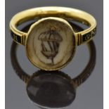 Georgian mourning ring set with an ivory plaque depicting an acorn and a black enamel band reading "