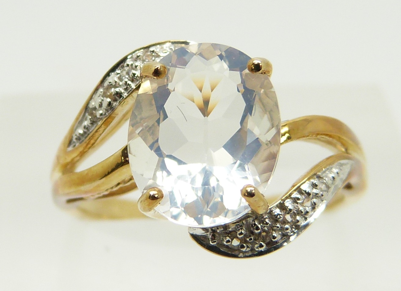 A 9ct gold ring set with an oval cut ice opal and diamonds, 2.8g, size M