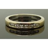 An 18ct gold diamond half eternity ring set with seven diamonds, size N, 4.00g