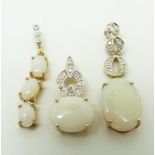 Three 9ct gold pendants set with oval opal cabochons and diamonds, 4.2g