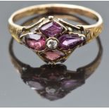 Georgian / Victorian rose gold ring marked 12 set with an old cut diamond and garnets on an engraved