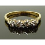 An 18ct gold ring set with four diamonds in a platinum setting, size R/S, 3.00g