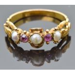 An early Victorian ring set with split pearls and foiled pink sapphires with engraved and pierced