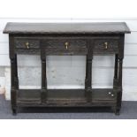 A carved oak hall table with three drawers and undershelf, W95 x D35 x H70cm