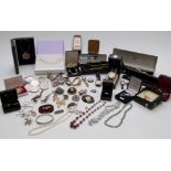 A collection of costume jewellery including silver watch, Miracle brooch, beads, coins, necklace