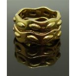 Two Cartier 18ct gold rings with raised oval decoration, size L/M, 13.48g