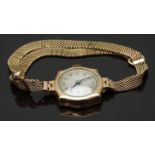 Swiss 9ct gold ladies wristwatch with blued hands, black Arabic numerals, silver dial and 15 jewel