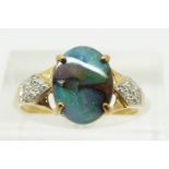 A 9ct gold ring set with an oval boulder opal cabochon of approximately 1.6cts and diamonds, 2.2g,