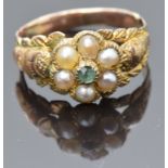 Victorian yellow metal ring set with an emerald and seed pearls with textured detail to the