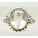 A 9ct gold ring set with an oval cut ice opal surrounded by zircon, 2.8g, size S