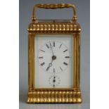 A 19thC gilt brass carriage clock with moulded decoration to corniche style case, the half hourly