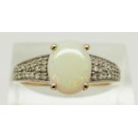 A 9ct gold ring set with an oval Ethiopian opal cabochon and diamonds, size R, 2.5g