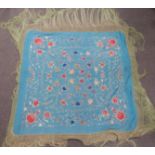 A 19th/20thC Chinese shawl with embroidered floral decoration and long fringe, 200 x 200cm including