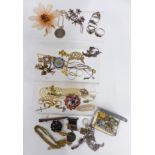 A collection of jewellery including Corocraft brooch, silver St Christopher, silver rings, cap
