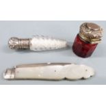 Hallmarked silver and mother of pearl folding fruit knife and two white metal lidded scent bottles