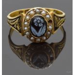 Victorian 15ct gold ring set with a carved flower surrounded by seed pearls, with enamel