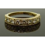 An 18ct gold half eternity ring set with nine diamonds each approximately 0.1ct, size K, 2.90g