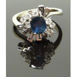 A white gold ring marked 14k set with an oval cut sapphire and diamonds, 4.5g, size J