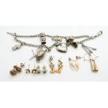 A silver charm bracelet with nine silver charms including gypsy caravan, heart pendant, etc and