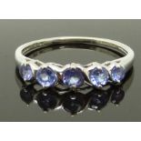 A 9ct white gold ring set with tanzanites, size N, 1.59g