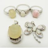 Two silver rings one set with a pink opal and the other a yellow opal, a silver pendant set with a