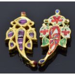 A pair of Indian yellow metal pendants set with enamel to one side and foiled rubies set to the