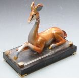Art Deco style ceramic gazelle raised on a stepped base, marked to rear possibly Mangani, height